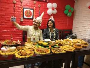 Couple celebrating with a traditional Bengali meal at Vojon Rosik Restaurant